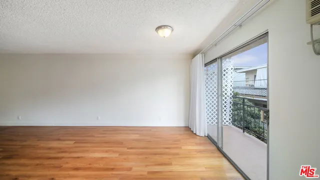a view of a room with wooden floor and windows