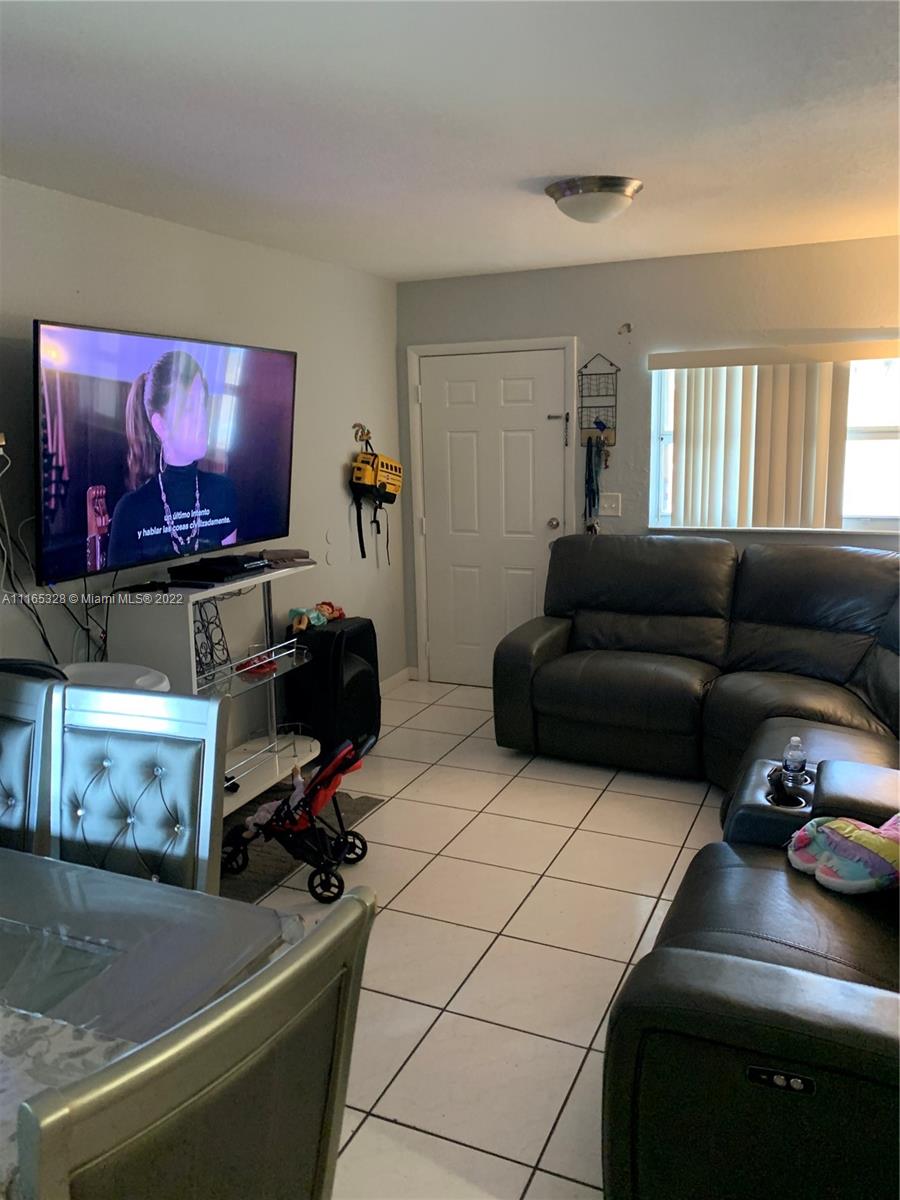 Allapattah Miami, FL 33142 - Photo 2 of 3 a living room with furniture and a flat screen tv