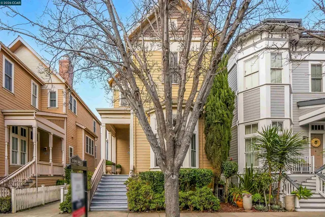 a front view of a residential houses with yard