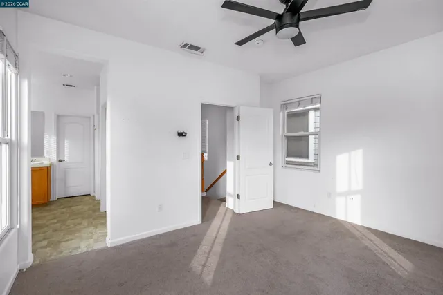 a view of a room with window and hardwood floor