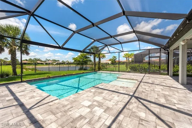 a view of a backyard with table and chairs under an umbrella