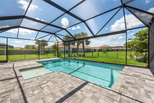 an aerial view of residential houses with outdoor space and parking