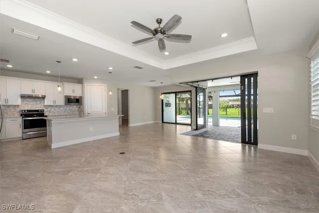 a view of an empty room with a kitchen