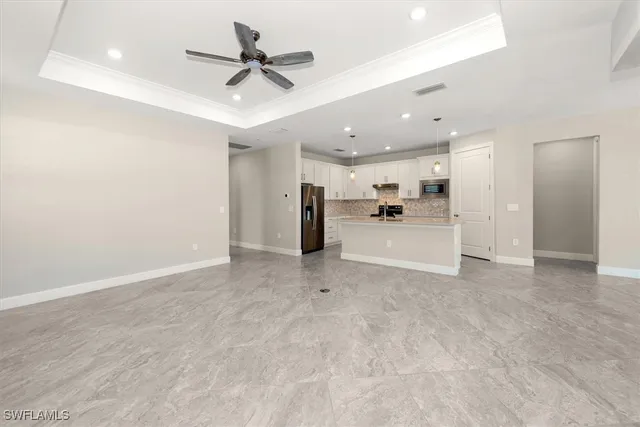 a view of a kitchen with a sink and stainless steel appliances