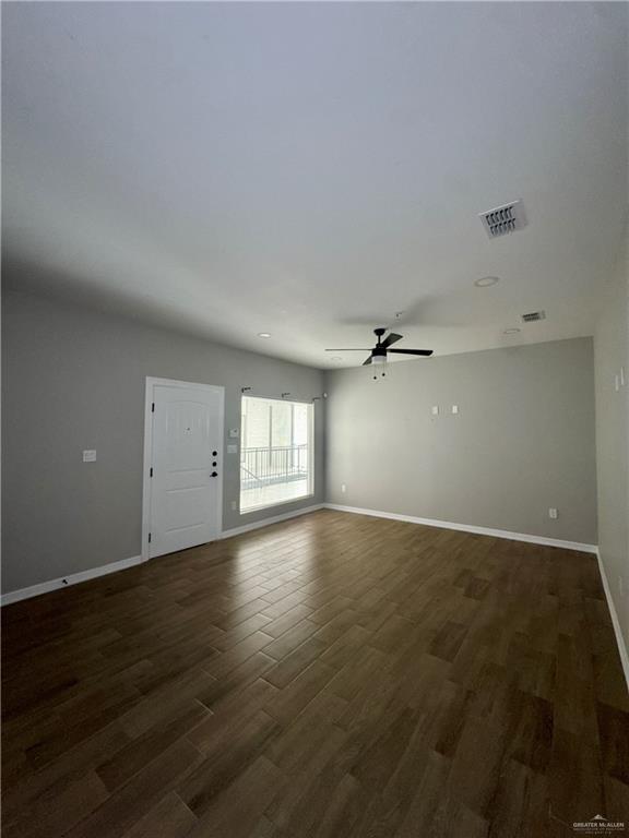 720 Ragland Road, Unit 8 Mission, TX 78572 - Photo 3 of 17 an empty room with wooden floor and windows