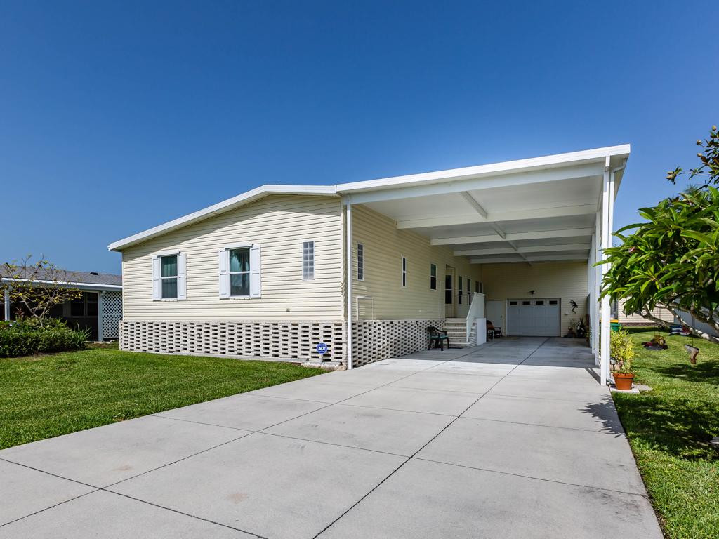 253 Riverwood Road Naples, FL 34114 - Photo 1 of 18 a view of a house with a backyard