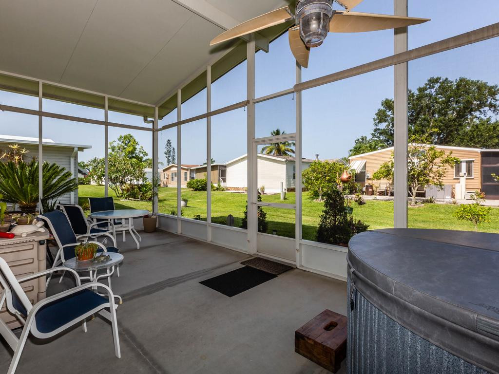 253 Riverwood Road Naples, FL 34114 - Photo 2 of 18 a view of a porch with furniture