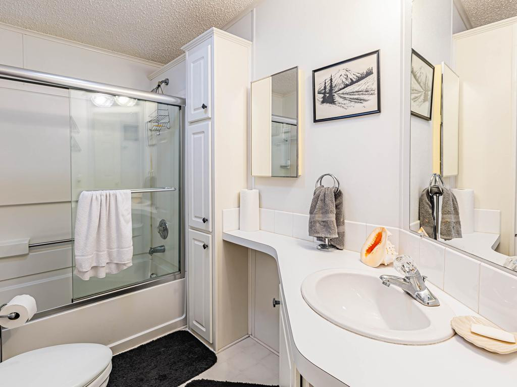 253 Riverwood Road Naples, FL 34114 - Photo 12 of 18 a bathroom with a sink toilet and shower
