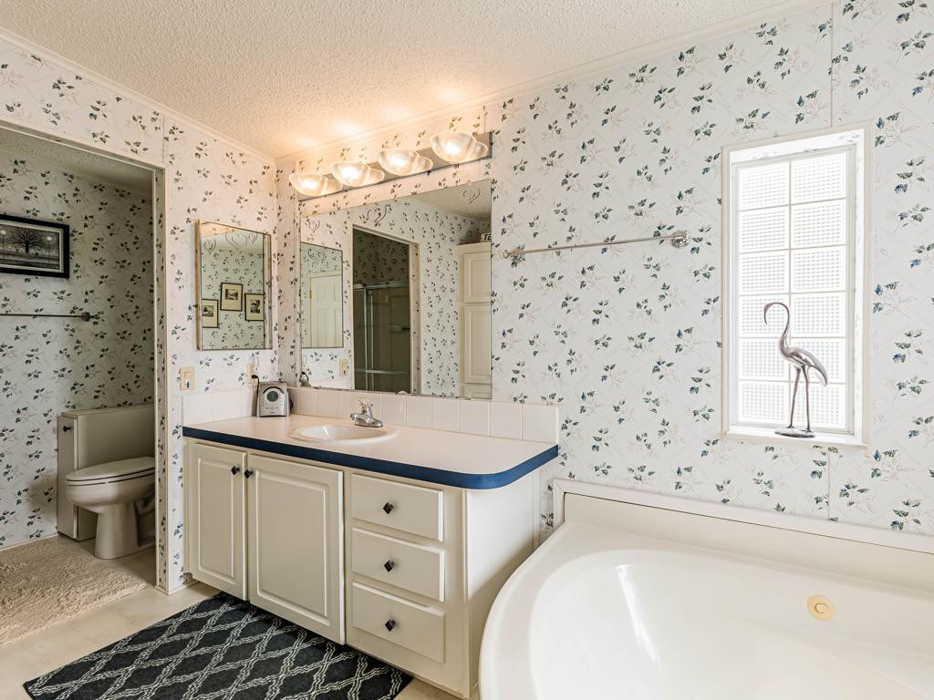253 Riverwood Road Naples, FL 34114 - Photo 13 of 18 a bathroom with a sink and a mirror