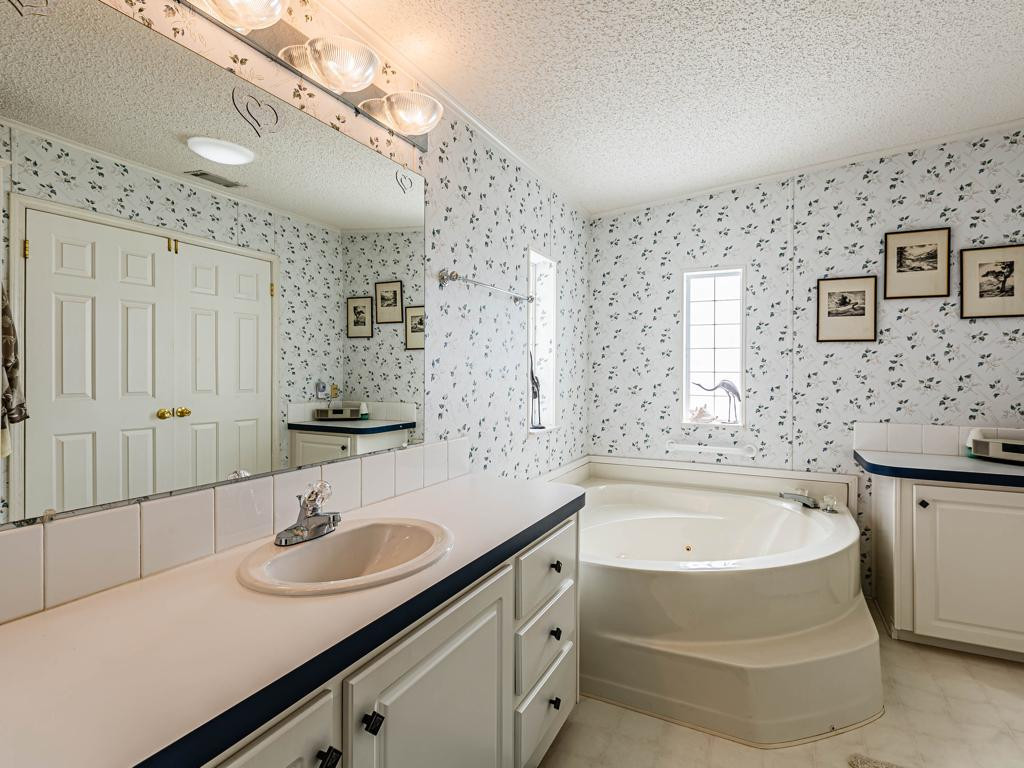 253 Riverwood Road Naples, FL 34114 - Photo 14 of 18 a bathroom with a sink and a bathtub