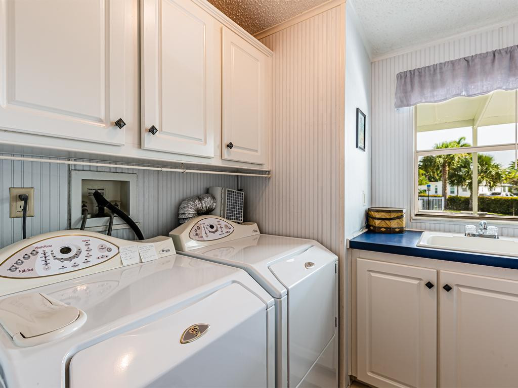 253 Riverwood Road Naples, FL 34114 - Photo 5 of 18 a utility room with dryer and washer