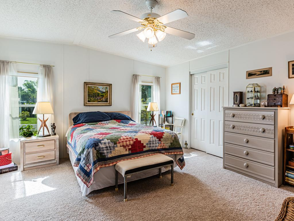 253 Riverwood Road Naples, FL 34114 - Photo 6 of 18 a spacious bedroom with a bed and a dresser