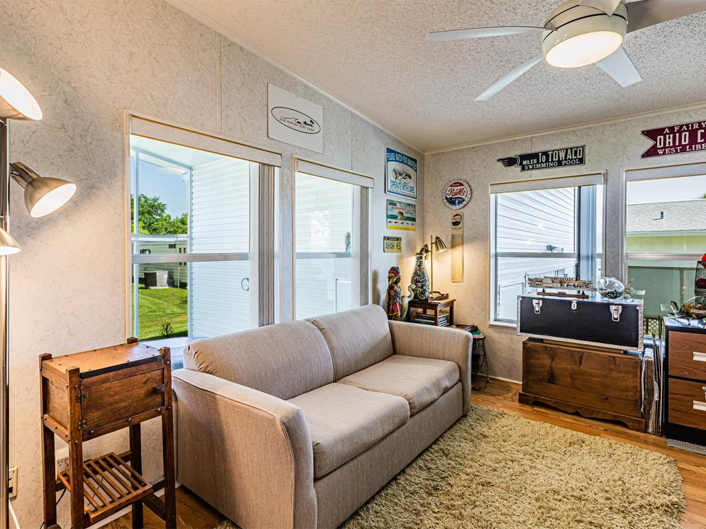 253 Riverwood Road Naples, FL 34114 - Photo 8 of 18 a living room with furniture window and wooden floor