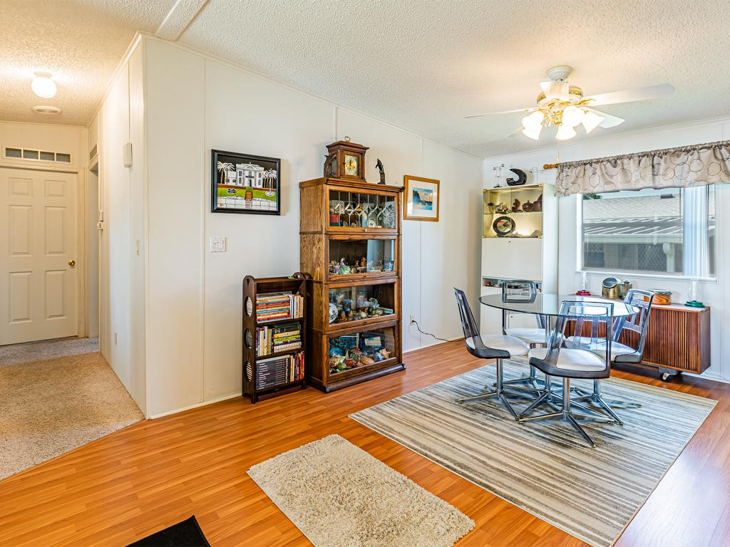 253 Riverwood Road Naples, FL 34114 - Photo 10 of 18 a living room with fireplace furniture and a book shelf