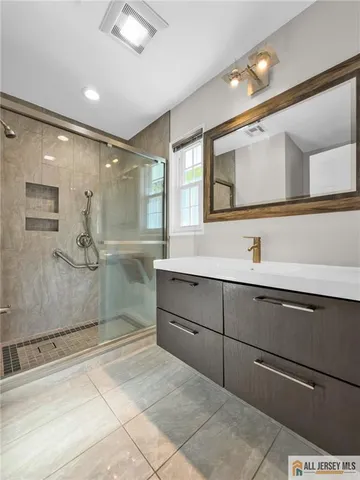 a bathroom with a sink mirror and a shower