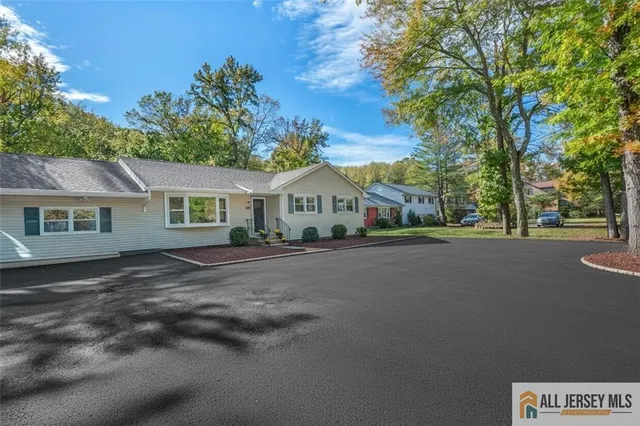 a view of house with outdoor space and tree in the background
