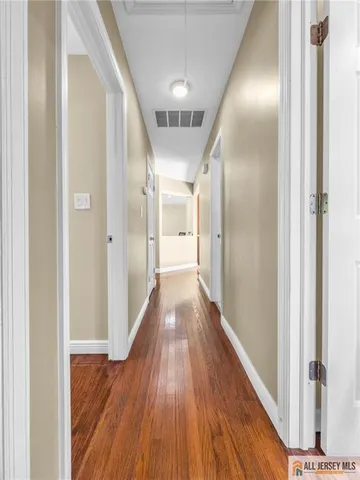 a view of hallway with wooden floor