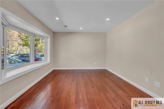 a view of room with window and wooden floor