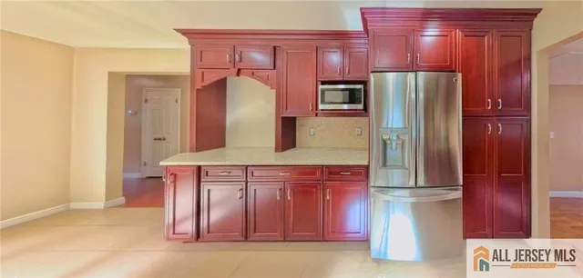 a kitchen with a refrigerator a sink and cabinets