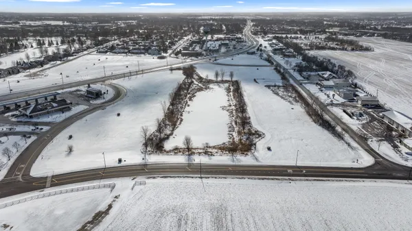 an aerial view of a residential building and parking space