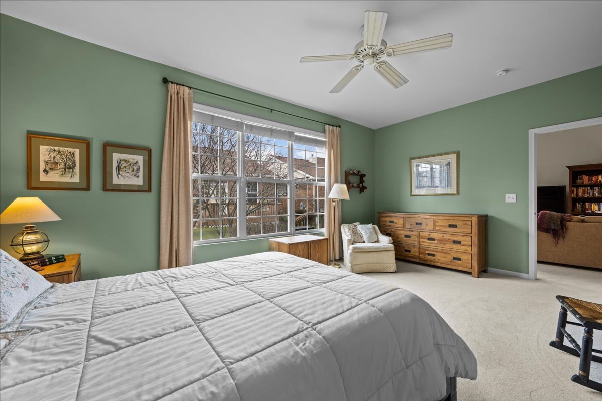 2866 Bond Circle Naperville, IL 60563 - Photo 14 of 28 a bedroom with a bed and a chandelier