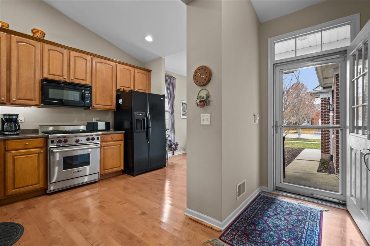 2866 Bond Circle Naperville, IL 60563 - Photo 4 of 28 a kitchen with stainless steel appliances granite countertop a refrigerator and a stove top oven