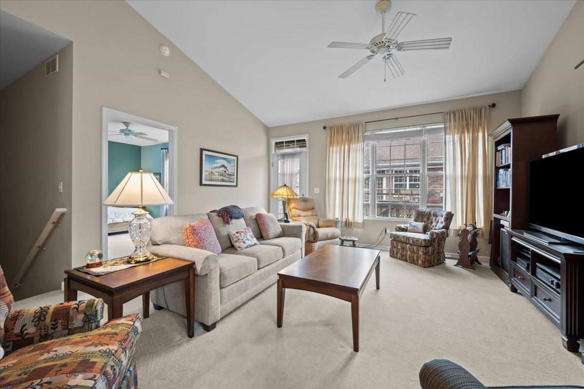 2866 Bond Circle Naperville, IL 60563 - Photo 6 of 28 a living room with furniture a flat screen tv and a large window