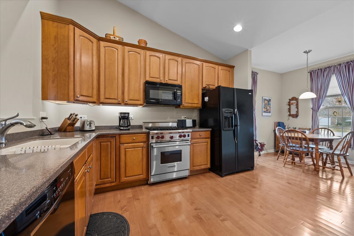 2866 Bond Circle Naperville, IL 60563 - Photo 9 of 28 a kitchen with stainless steel appliances granite countertop a refrigerator stove microwave and sink