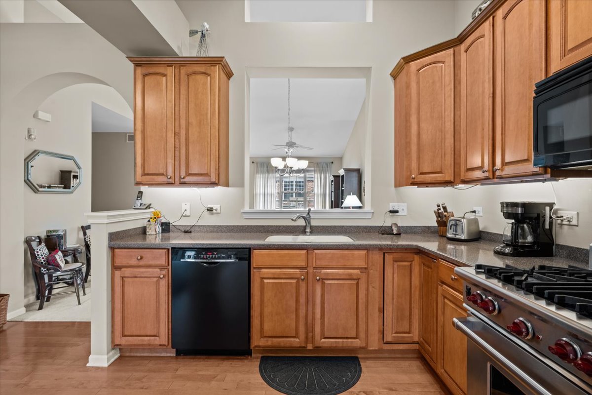 2866 Bond Circle Naperville, IL 60563 - Photo 10 of 28 a kitchen with stainless steel appliances granite countertop a sink stove and cabinets