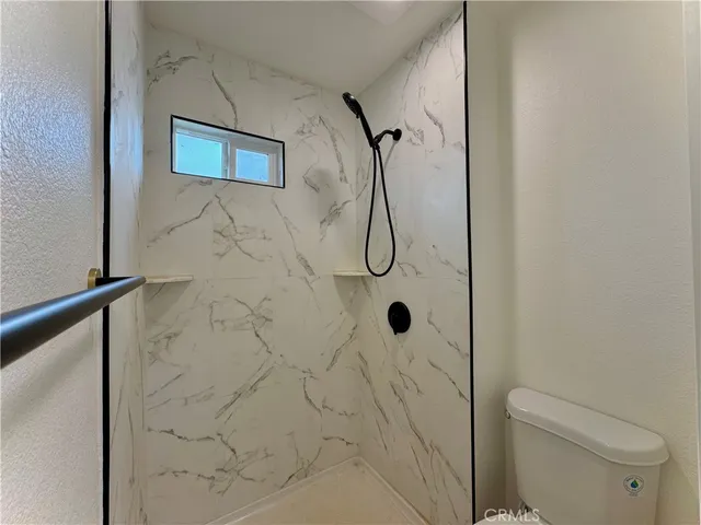 a bathroom with a shower toilet and sink