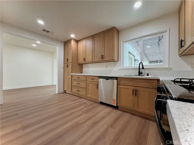 a kitchen with wooden floors and a sink