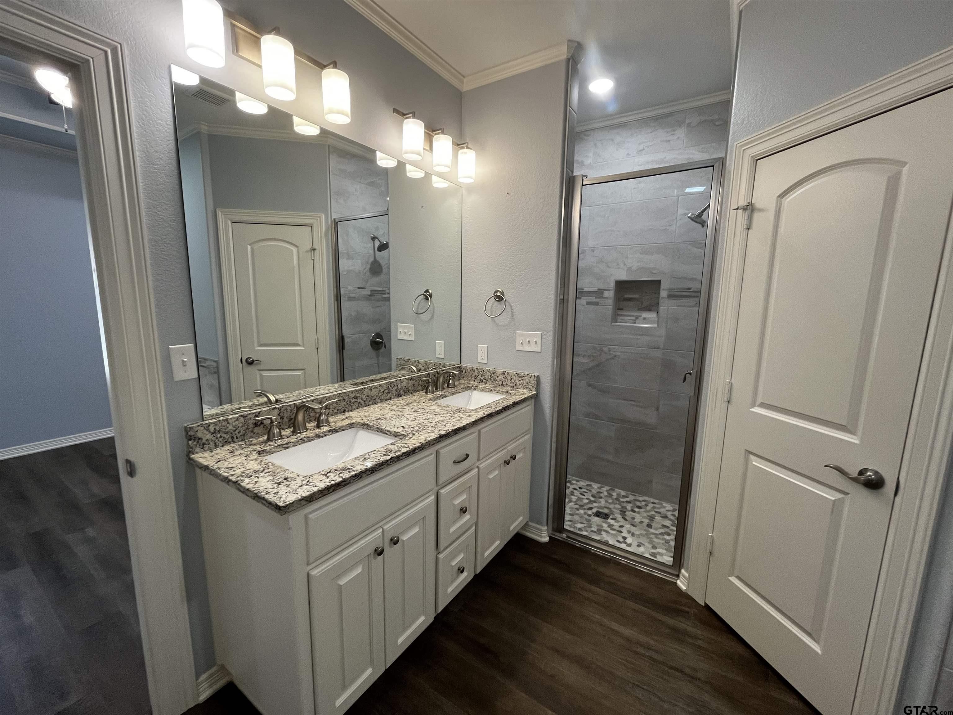 136 Letha Court Tyler, TX 75702 - Photo 13 of 34 a bathroom with a granite countertop sink a toilet a mirror and shower