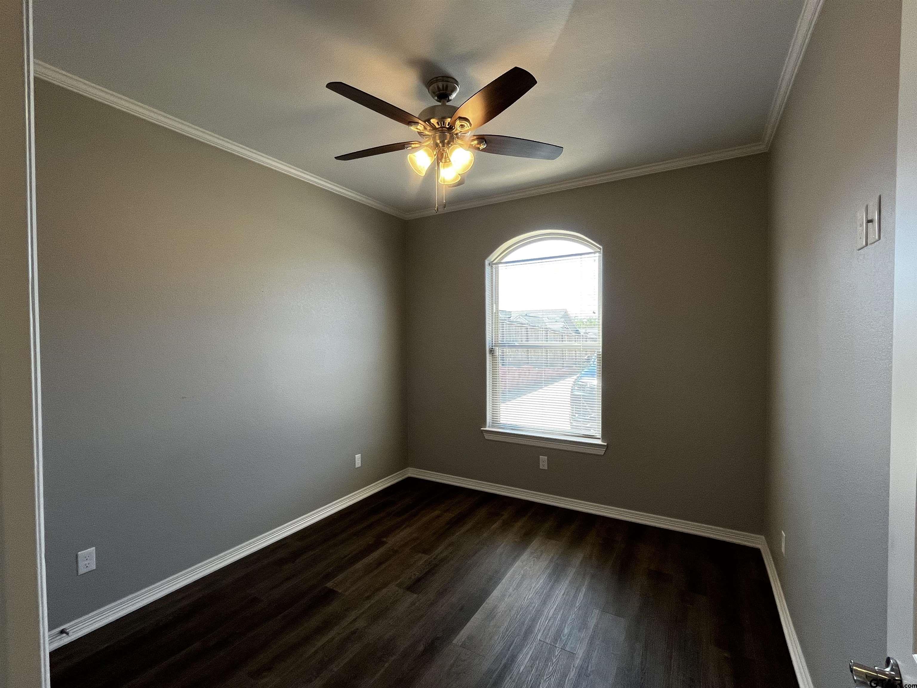 136 Letha Court Tyler, TX 75702 - Photo 18 of 34 an empty room with wooden floor fan and windows