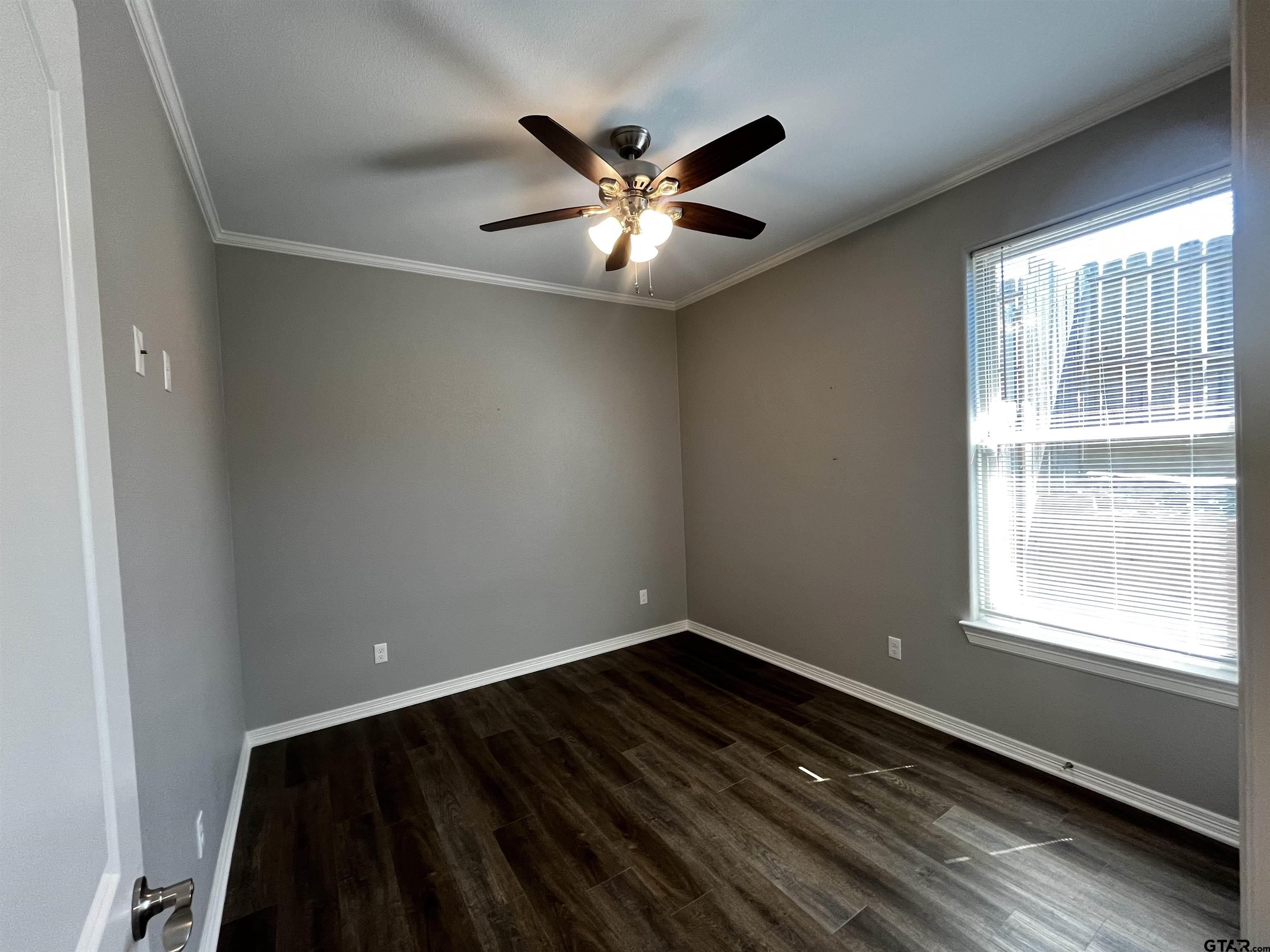 136 Letha Court Tyler, TX 75702 - Photo 21 of 34 a view of an empty room with wooden floor and a window