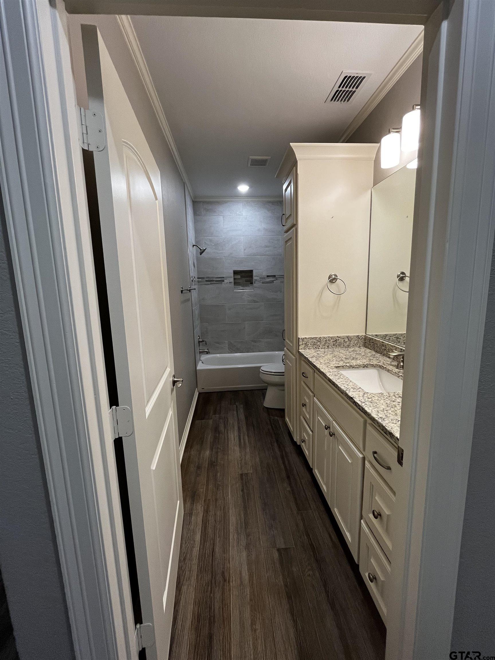 136 Letha Court Tyler, TX 75702 - Photo 24 of 34 a bathroom with a double vanity sink and a mirror