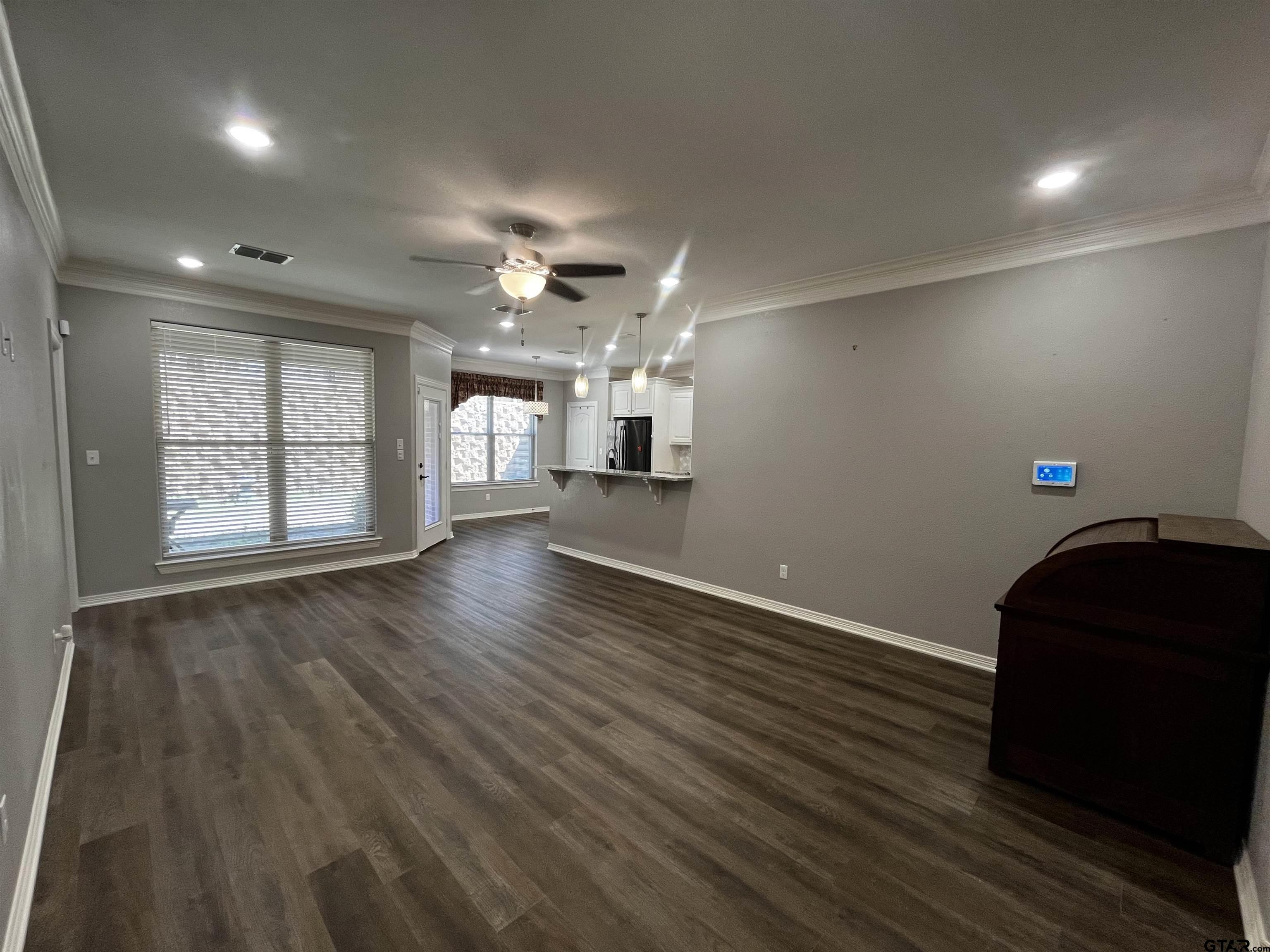 136 Letha Court Tyler, TX 75702 - Photo 5 of 34 an empty room with wooden floor and windows
