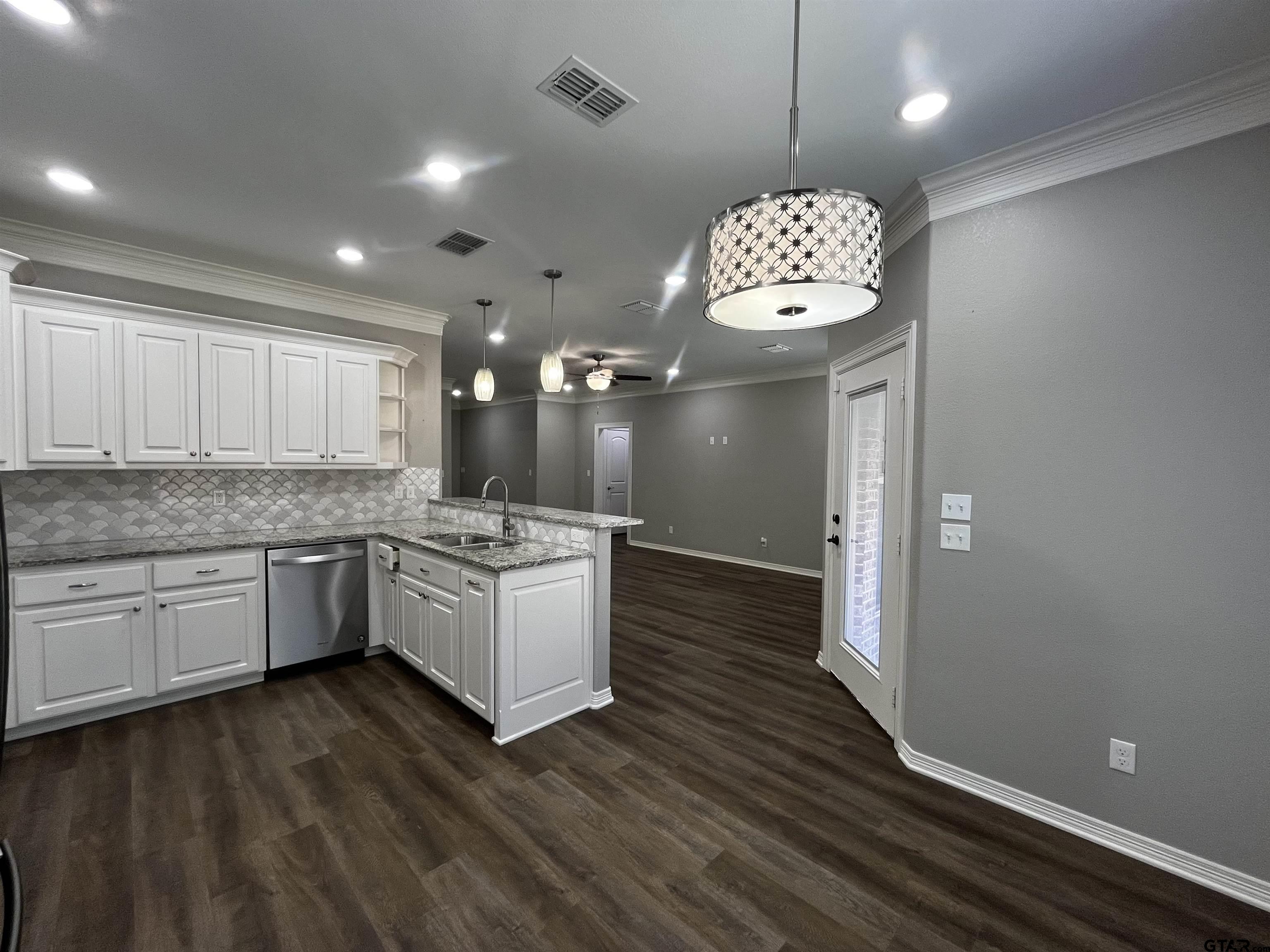 136 Letha Court Tyler, TX 75702 - Photo 9 of 34 a kitchen with a refrigerator and window