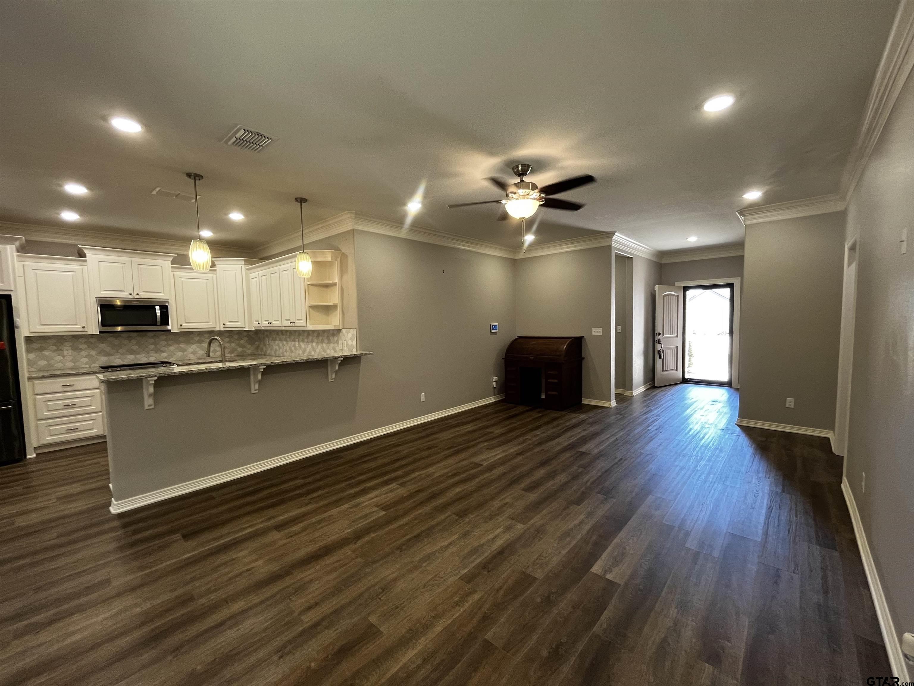 136 Letha Court Tyler, TX 75702 - Photo 10 of 34 a view of a kitchen with a sink a refrigerator and a stove