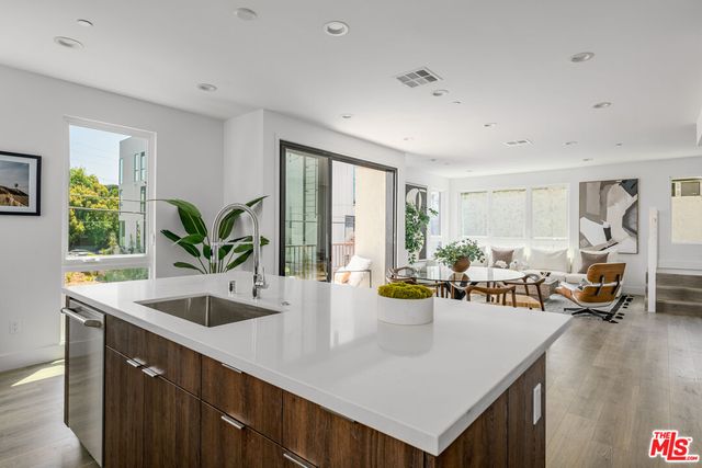 a view of kitchen island a dining table chairs and couches