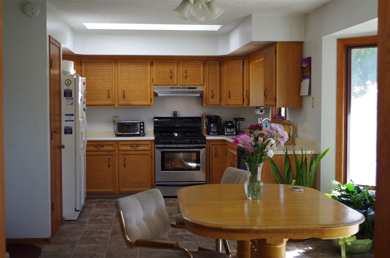 3154 Freeport Road Rockton, IL 61072 - Photo 10 of 15 a kitchen with a stove a sink and a refrigerator