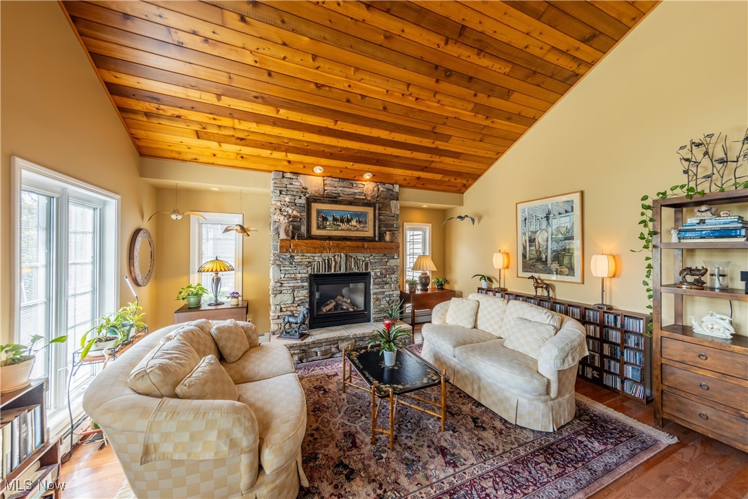 8405 Dines Road Novelty, OH 44072 - Photo 4 of 45 Great room features an abundance of natural light from large Pella palladium windows, wood paneled high vaulted ceiling, and large stone gas fireplace.