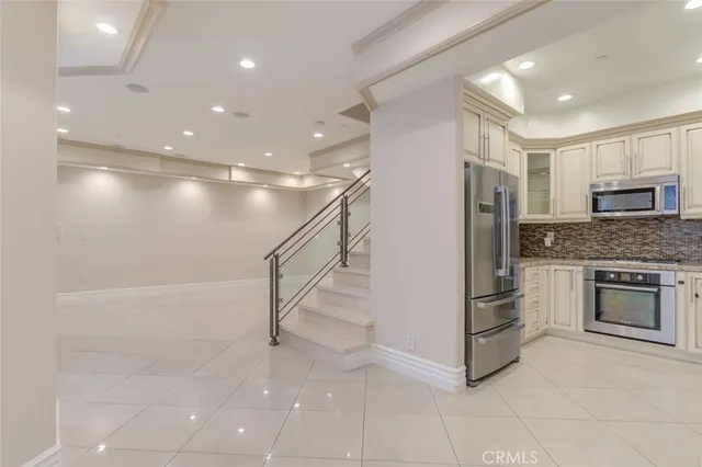a kitchen with granite countertop white cabinets and a sink