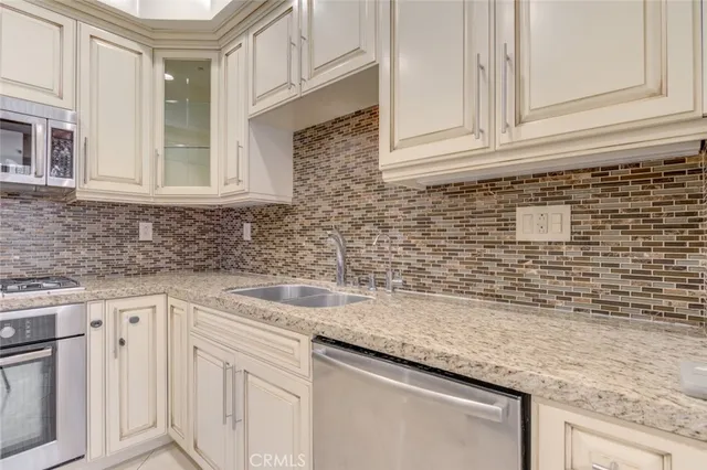 a stove top oven sitting inside of a kitchen
