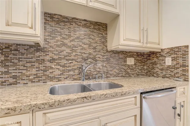 a bathroom with a granite countertop sink a mirror and a vanity