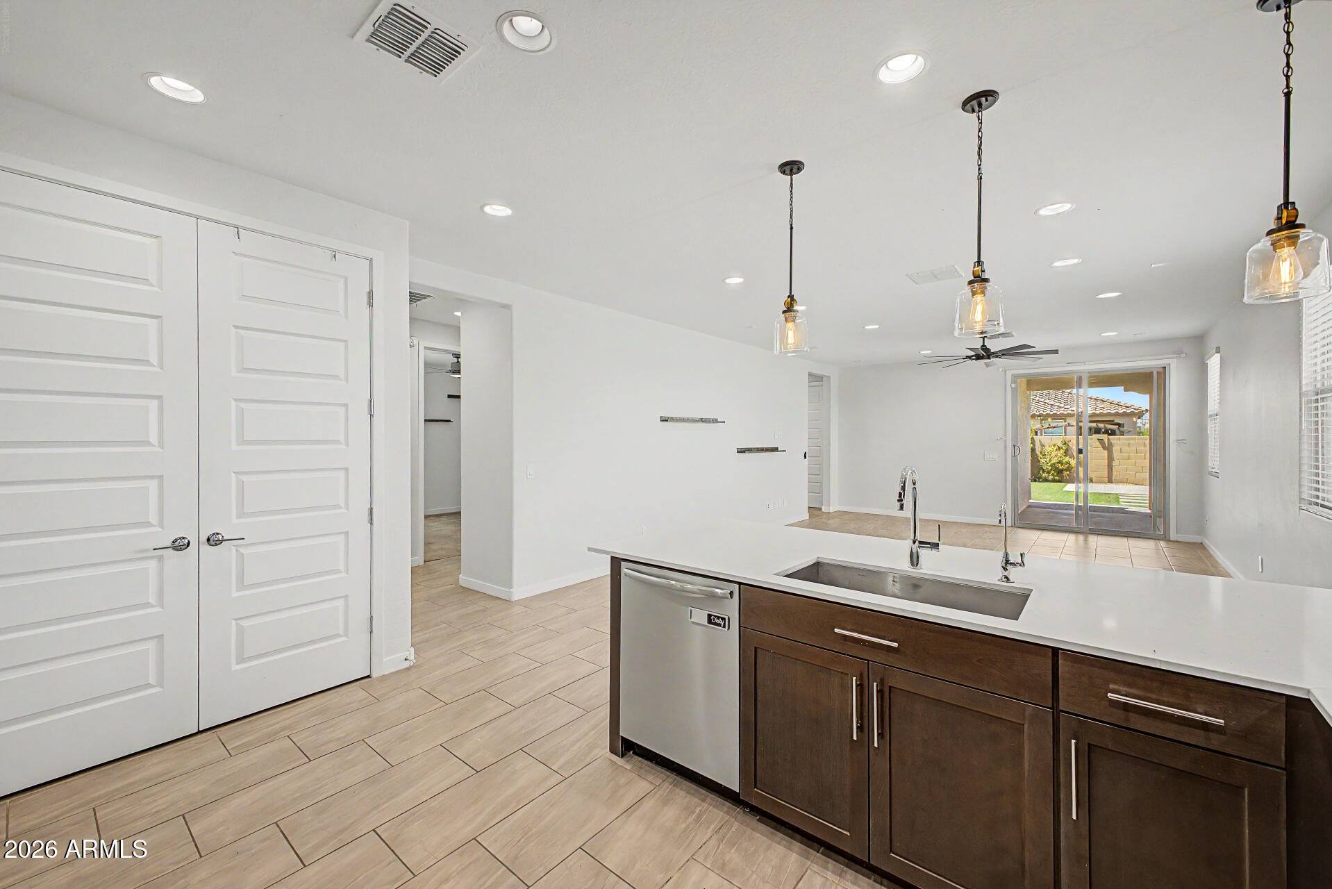 23080 East Stacey Road Queen Creek, AZ 85142 - Photo 9 of 42 a kitchen with kitchen island white cabinets and sink
