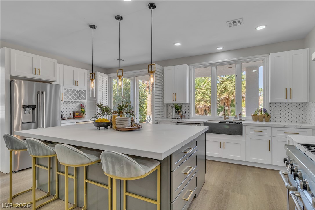 8848 Rainbow Ridge Drive Las Vegas, NV 89117 - Photo 15 of 43 A well-appointed kitchen features a large central island, stainless steel appliances, and ample natural light.