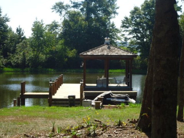 1900 Bonner Gilbert Road Macon, GA 31220 - Photo 4 of 15 a view of a lake with a bench in a lake