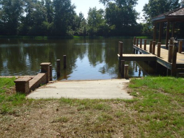 1900 Bonner Gilbert Road Macon, GA 31220 - Photo 5 of 15 a view of a lake with a bench and trees around