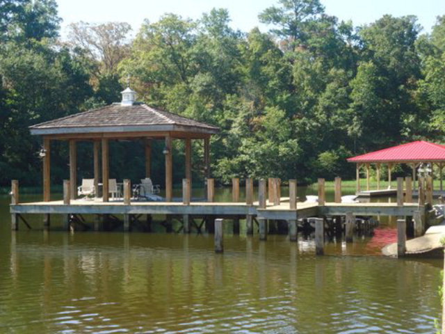 1900 Bonner Gilbert Road Macon, GA 31220 - Photo 9 of 15 a view of a lake with a table and chairs under an umbrella