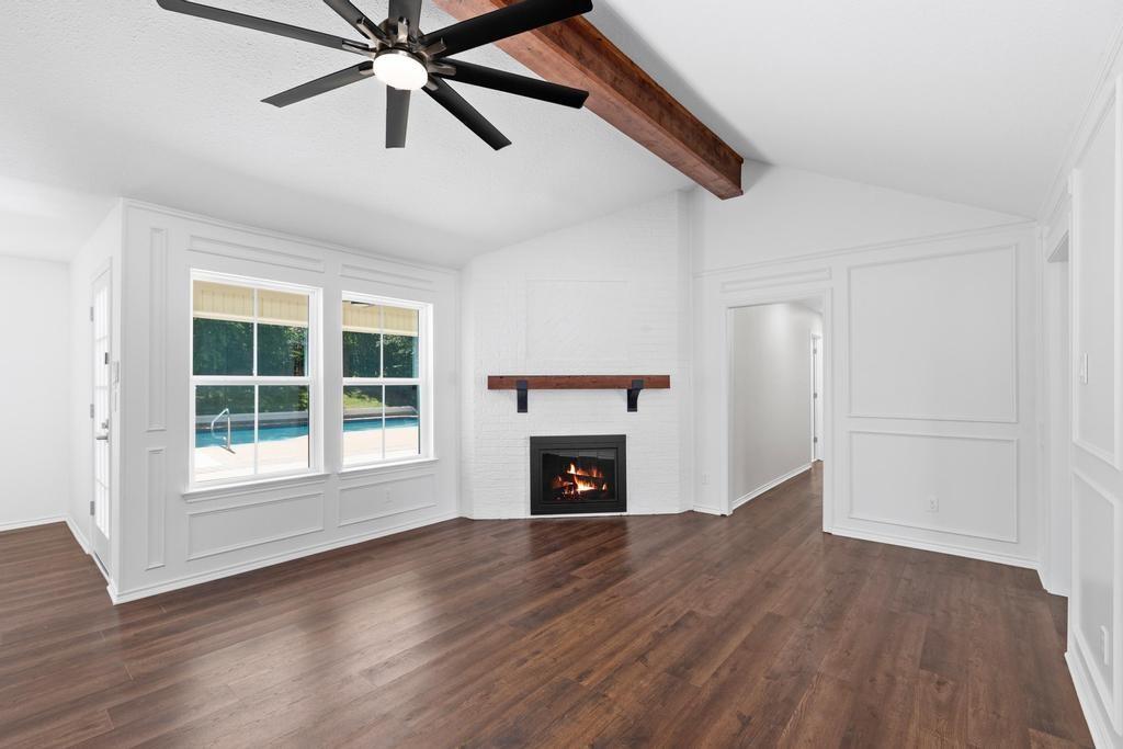 4501 Ridgeway Road Fort Worth, TX 76126 - Photo 13 of 39 a view of an empty room with wooden floor fireplace and a window